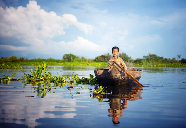 Cambodian boy Travel by boat